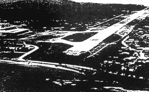 A black and white photo of an airport runway.